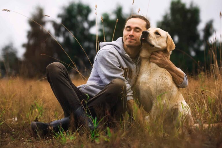 Featured: golden retriever hugs man