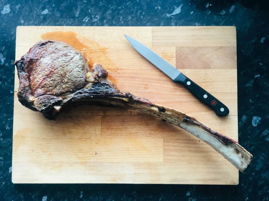 Meat bone on a wooden chopping board
