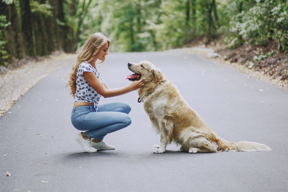 Woman walking outdoors with her dog