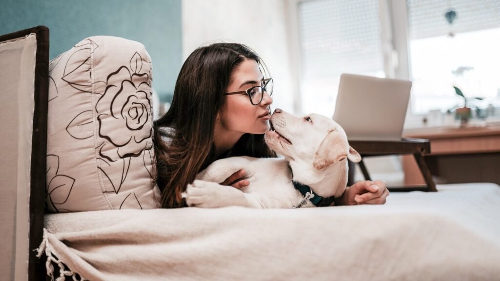 Woman kissing puppy