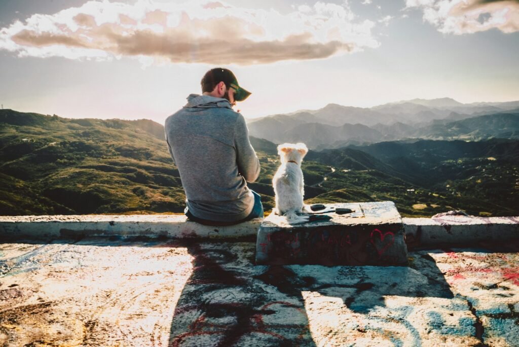 Man sitting beside dog